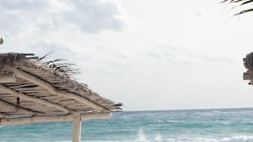 On the beach, white sand, sun loungers