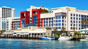 A waterfront hotel with multiple buildings, a dock with boats, and a clear blue sky. - Oceanfront Stylish Studio with Rooftop Pool (miami)