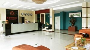 A hotel reception area with a reception desk, chairs, a chandelier, and a reception counter. - Ningbo Sunshine Yiran Hotel (Ningbo)