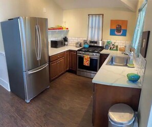 Enjoy cooking in this well-equipped kitchen with a refrigerator, stove, and sink.