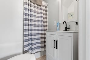 Bathtub, hair dryer, towels, soap