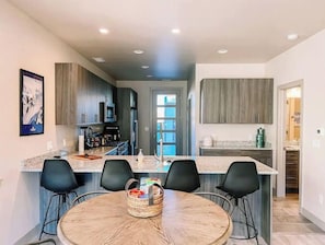 Enjoy meals and socializing at the central island breakfast bar in this well-equipped kitchen.