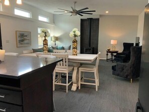 Relax in this inviting space with a dining area, kitchen, and comfortable seating for a cozy retreat.