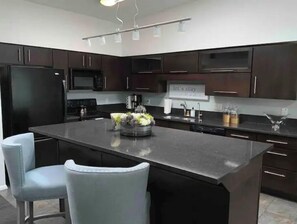 Enjoy cooking in this kitchen with a central island and microwave.