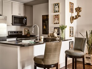 Enjoy casual dining around the island with comfortable chairs and a sleek kitchen design.