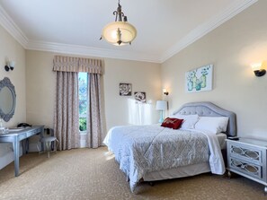 A bedroom with a bed, a desk, a chair, a nightstand, and a window with curtains. - Cozy Queen Mansion RM Near Monterey Carmel (Salinas)