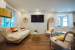 Relax in this stylish living room with a comfortable sofa, armchair, and coffee table, perfect for unwinding.