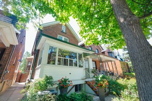 Stunning residential building with a charming front porch and elegant staircase.