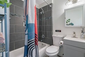 A modern bathroom with a shower, toilet, and sink. - Perfect & Cozy Home in A+ Location (Saint Petersburg)