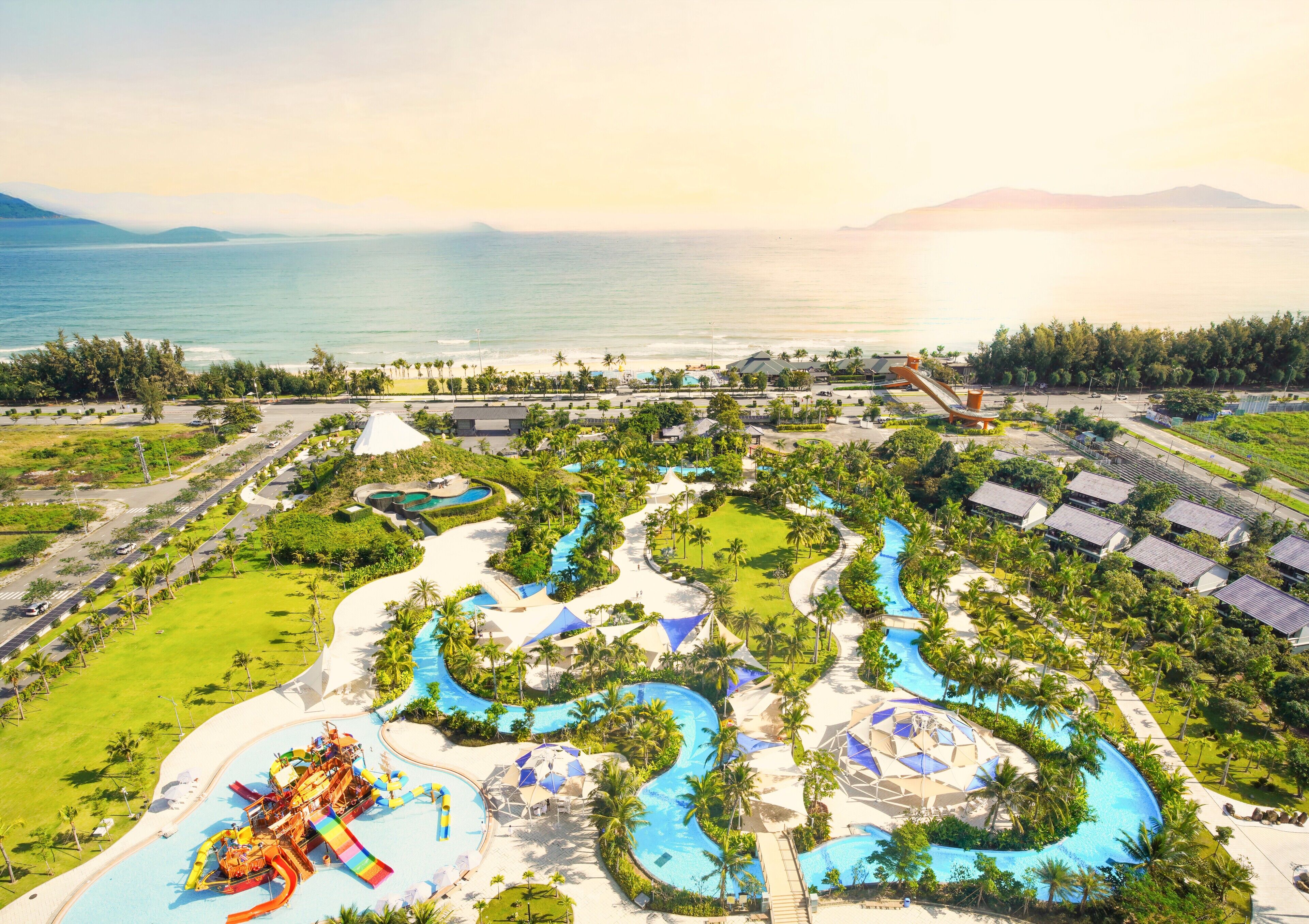 A resort with multiple swimming pools, a water park, and a beach.