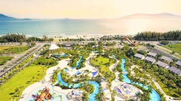 A resort with multiple swimming pools, a water park, and a beach.