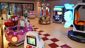 A carousel ride, a racing game, and a ride with a large illuminated face. - Mikazuki Villas - The Ryokan (Da Nang)