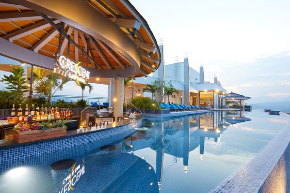 A poolside area with a bar, lounge chairs, and a sign for Crescent Cafe Bar. - Mikazuki Villas - The Ryokan (Da Nang)