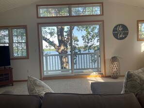 Relax in a serene lakeside setting with a comfortable seating area and stunning views from the deck.