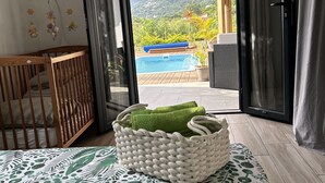 Een slaapkamer met uitzicht op een zwembad en bergen.