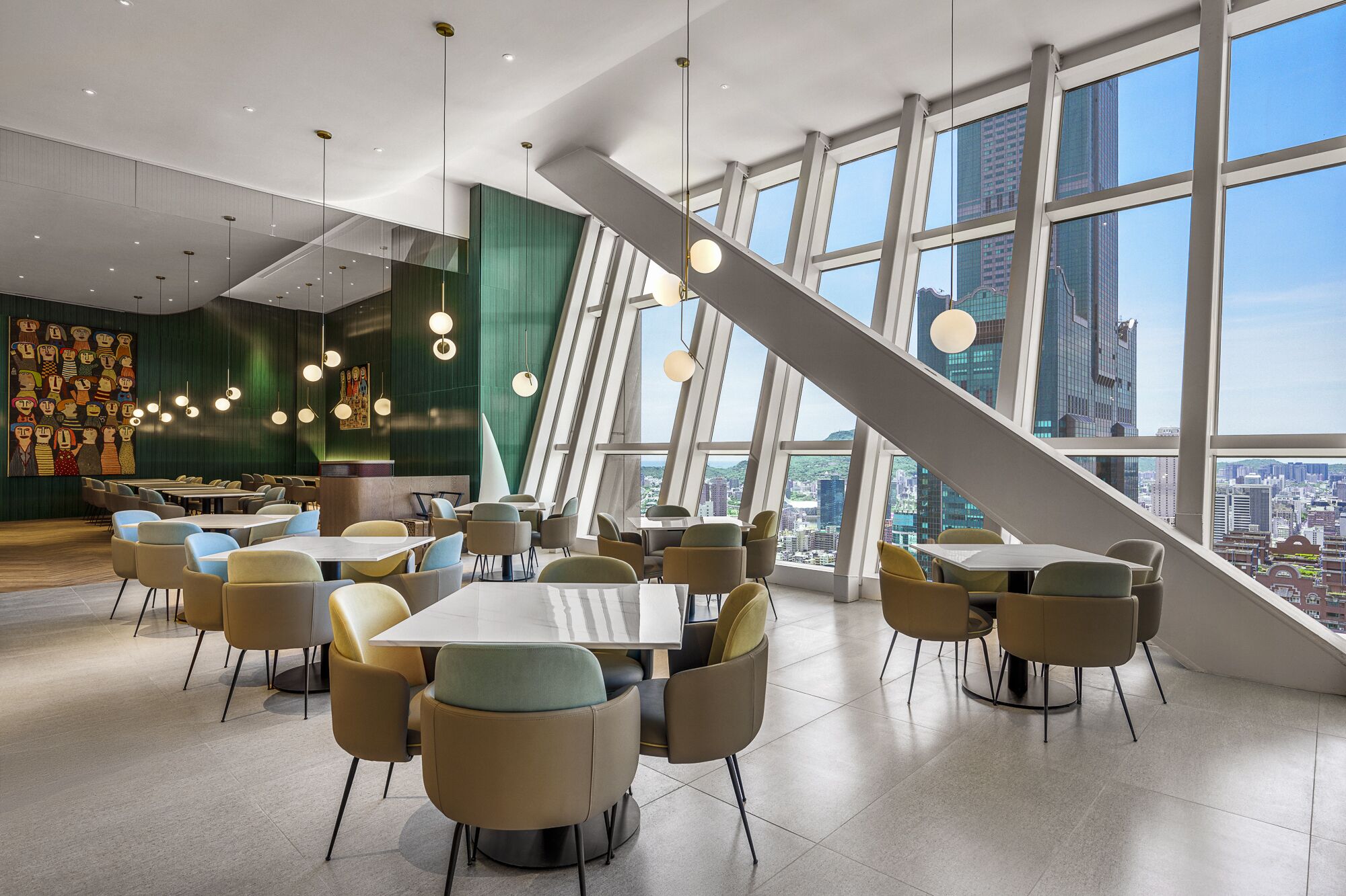 A modern dining area with tables and chairs, large windows with a city view, and hanging spherical lights.