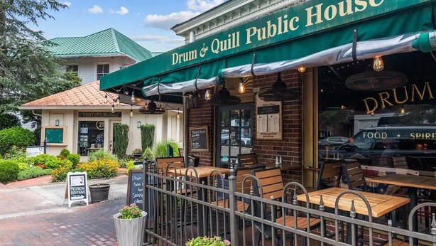 Drum & Quill Public House with outdoor seating and a brick facade. - Newly Renovated Property. (Pinehurst)