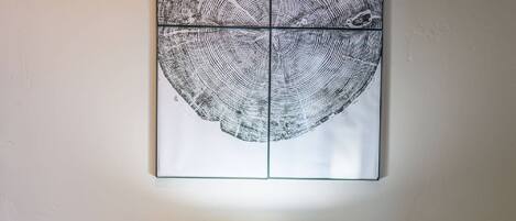 A wall-mounted artwork with a circular pattern.