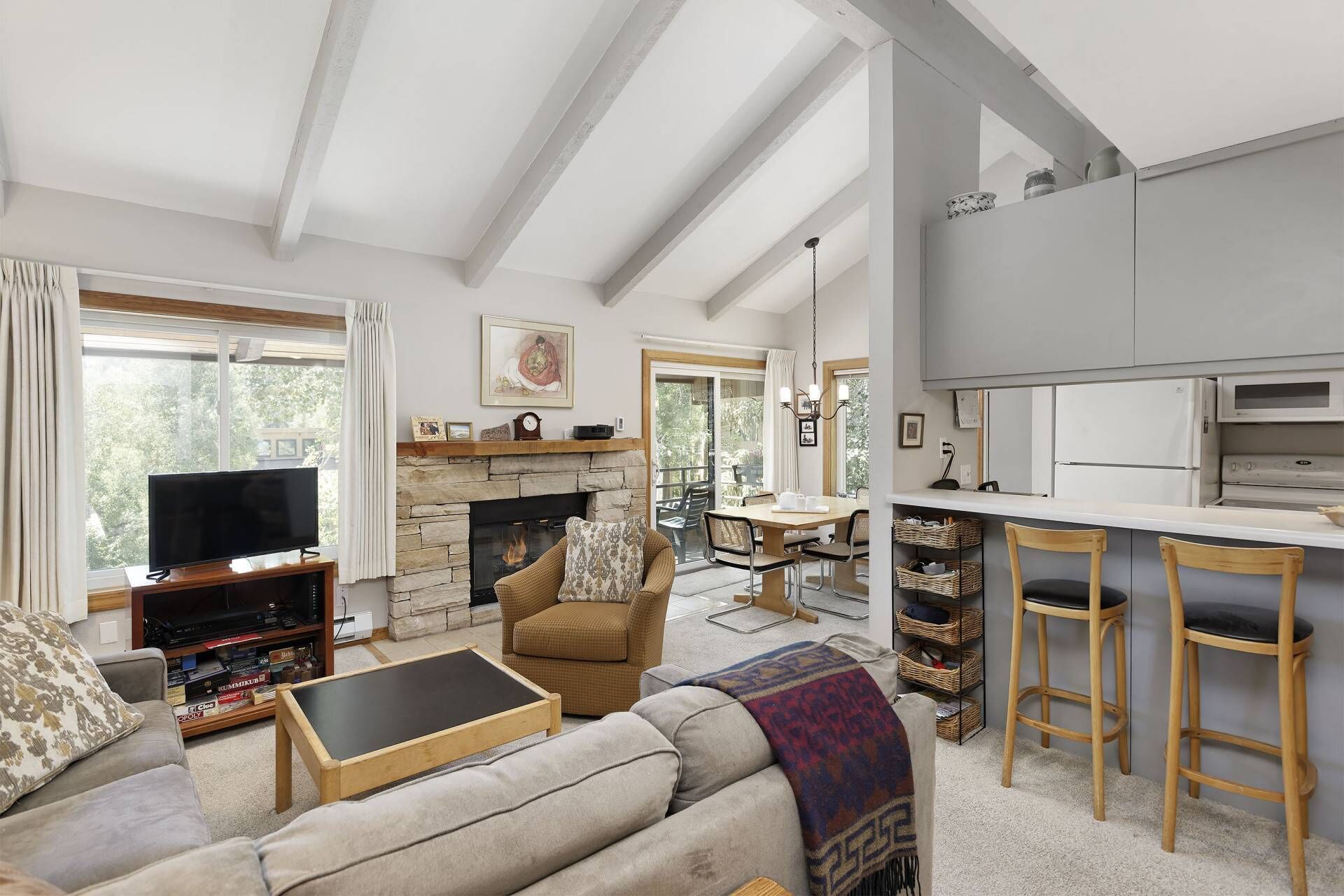 The open floor plan, vaulted ceilings and large windows and sliding door create a very inviting space to vacation.