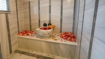 Designer toiletries, hair dryer, slippers, towels