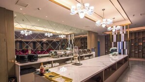 A modern hotel lobby with a long reception counter, glass partitions, and contemporary lighting fixtures. - LANOU Hotel (Haiyan Science City) (Haiyan)