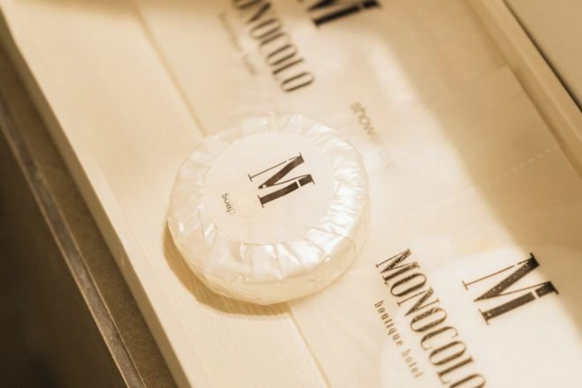 A soap bar with the brand name 'MONOCOLLO' and the letter 'N' on it.