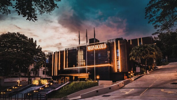 A modern building with a prominent 'Monocolo' sign, featuring a staircase leading to the entrance and a well-lit facade. - Monocolo Boutique Hotel (Kota Kinabalu)