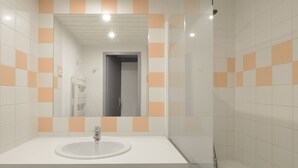 A bathroom with a white sink, a mirror, and a shower. - Comfortable renovated studio, south balcony, ski-in/ski-out (Plagne Aime 2000)