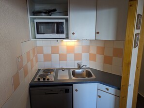A compact kitchen with a microwave, stove, sink, and dishwasher. - Functional divisible studio ski-in/ski-out with Mont Blanc view (Plagne Aime 2000)