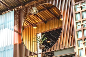 A circular wooden structure with hanging lights and a plant inside.