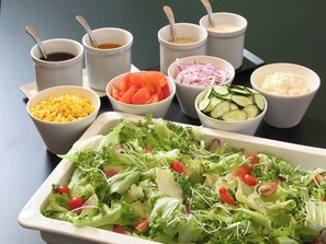 A table with various food items including a large salad, bowls of sliced vegetables, and small bowls of condiments. - Hotel and Spa Gift TAKAYAMA (Takayama)