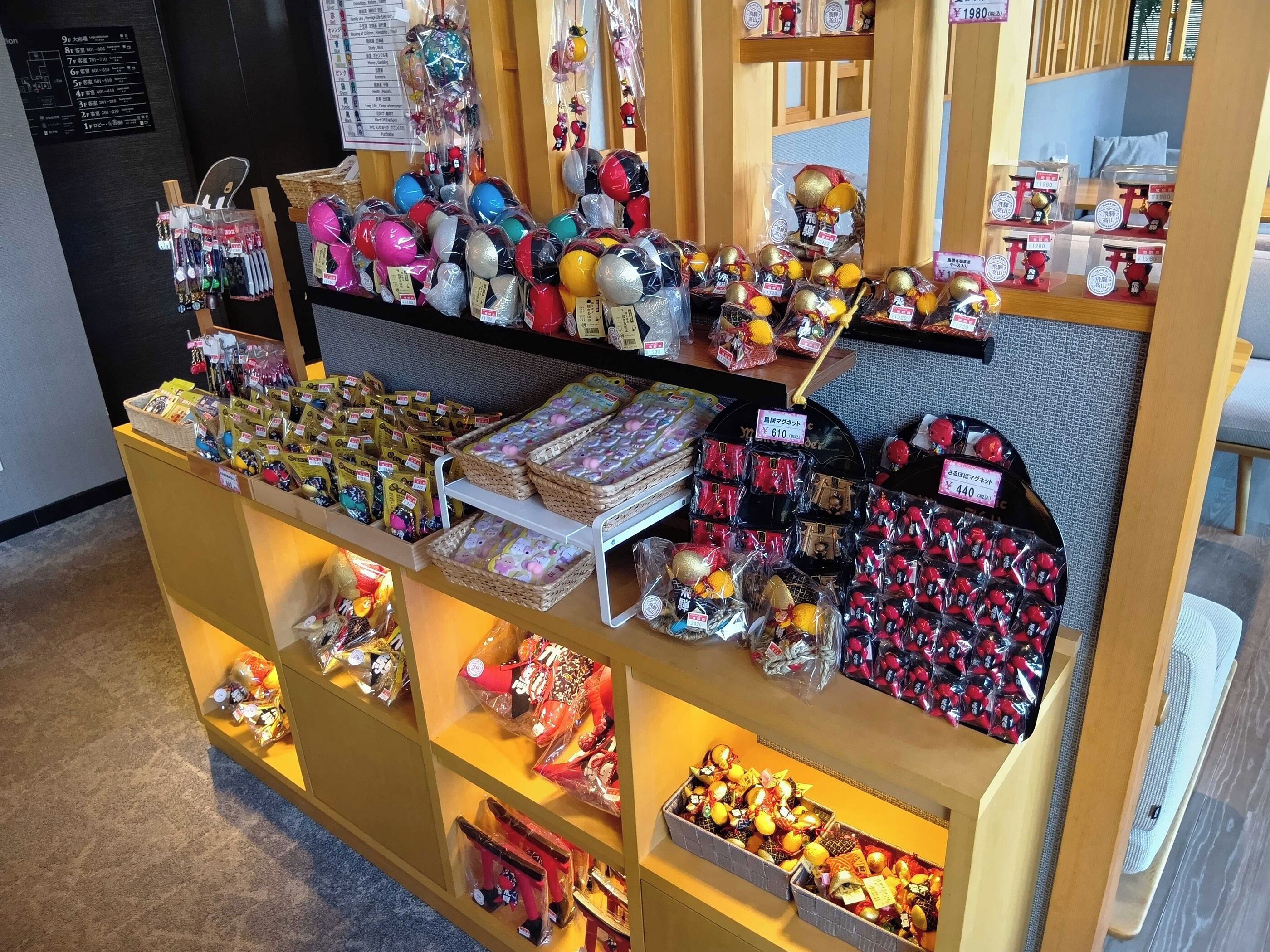 A display of various packaged goods, possibly souvenirs or gifts, arranged on shelves and in bins.