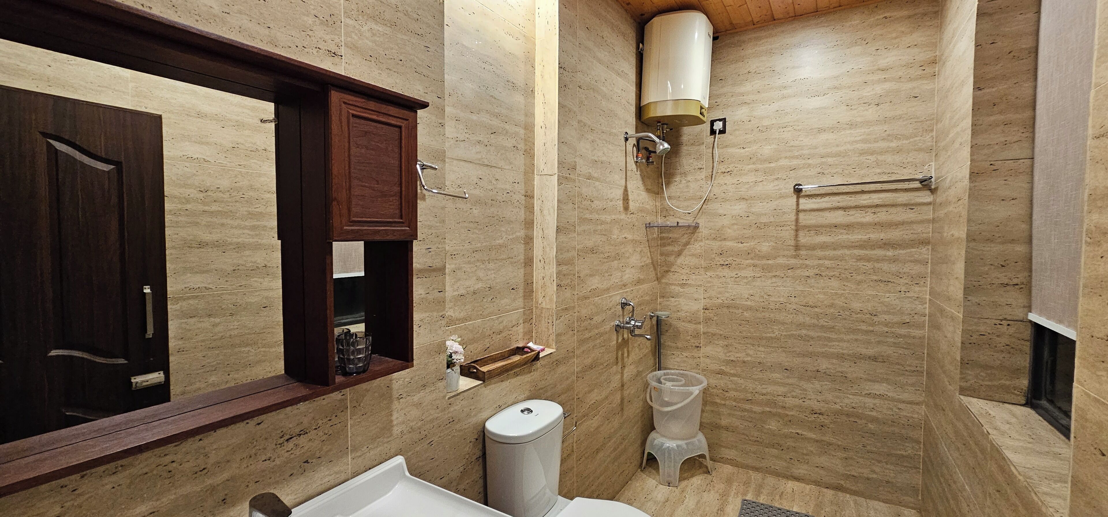 A bathroom with a shower, toilet, and sink.