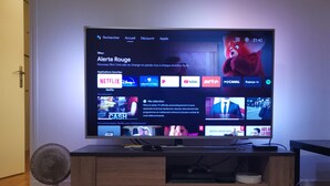 A television displaying a streaming service interface with various content options.