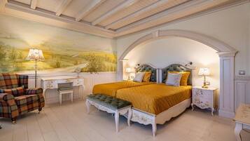 A bedroom with a large bed, two bedside tables, a desk, a chair, and a mural on the wall.