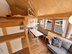 A wooden interior with a dining area, sofa, and a kitchen. - In the Center of Neustift - TWO Bedroom Apartment - sleeps 6 (Neustift im Stubaital)