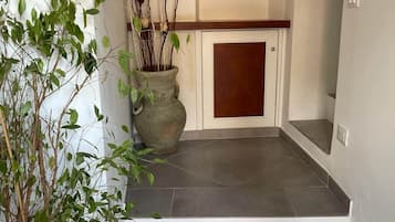 A staircase leading to a door with a decorative wall piece above it.