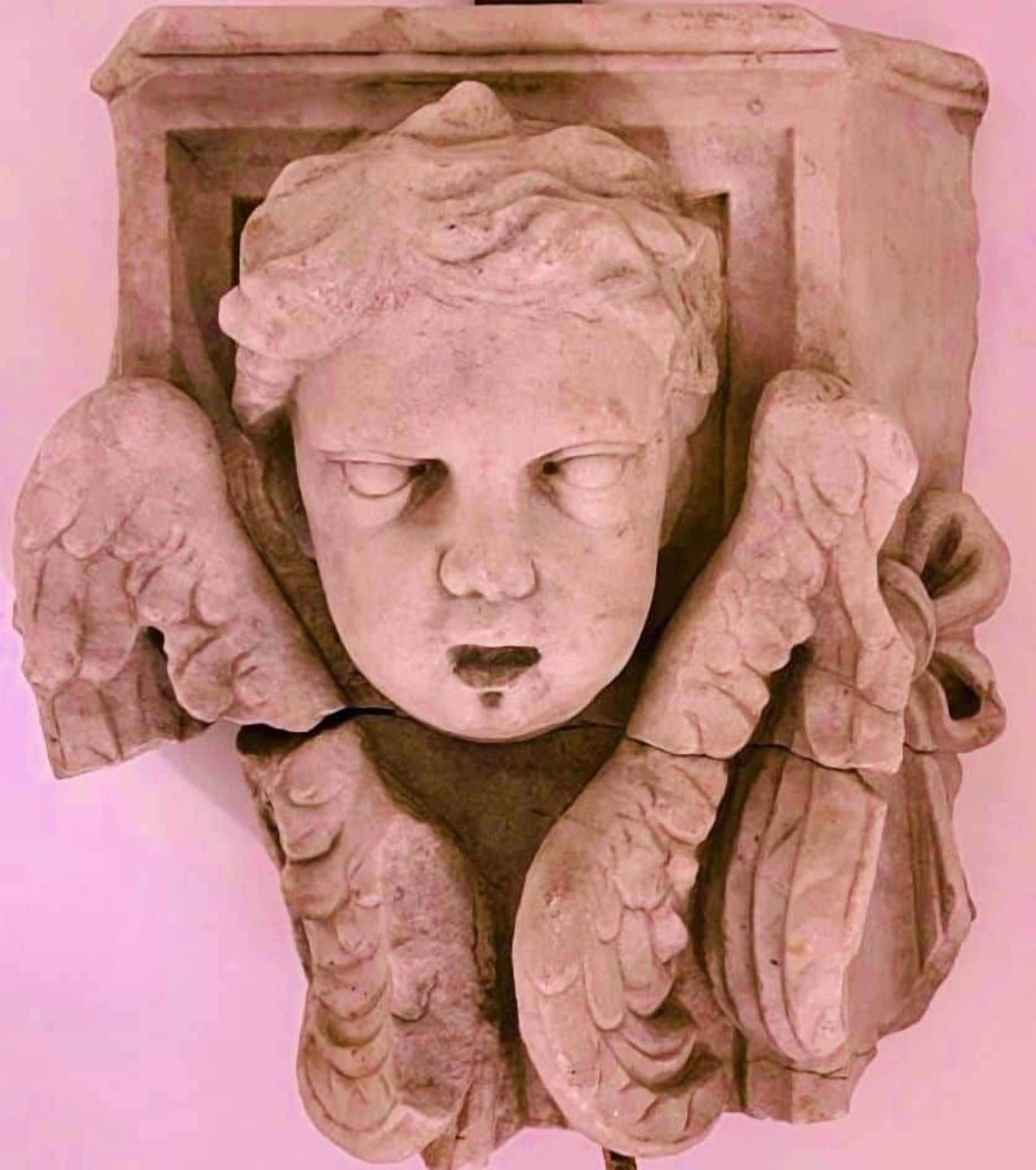 A stone sculpture with wings, possibly a decorative element.