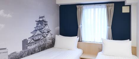 A hotel room with two beds, a large window with curtains, a wall mural of a traditional building, and a ceiling air vent.