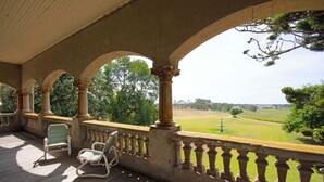 A covered porch with columns and a view of a green landscape. - Kilmany Park Estate (Wurruk)