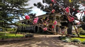 A large, historic building with a symmetrical facade, arched windows, and a central entrance. - Kilmany Park Estate (Wurruk)