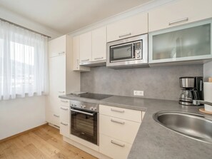 A modern kitchen with a built-in oven, microwave, and coffee maker. - In the Center of Neustift - TWO Bedroom Apartment - sleeps 5 (Neustift im Stubaital)