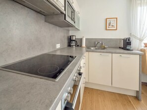 A modern kitchen with a built-in stovetop, a coffee maker, and a sink. - In the Center of Neustift - TWO Bedroom Apartment - sleeps 5 (Neustift im Stubaital)