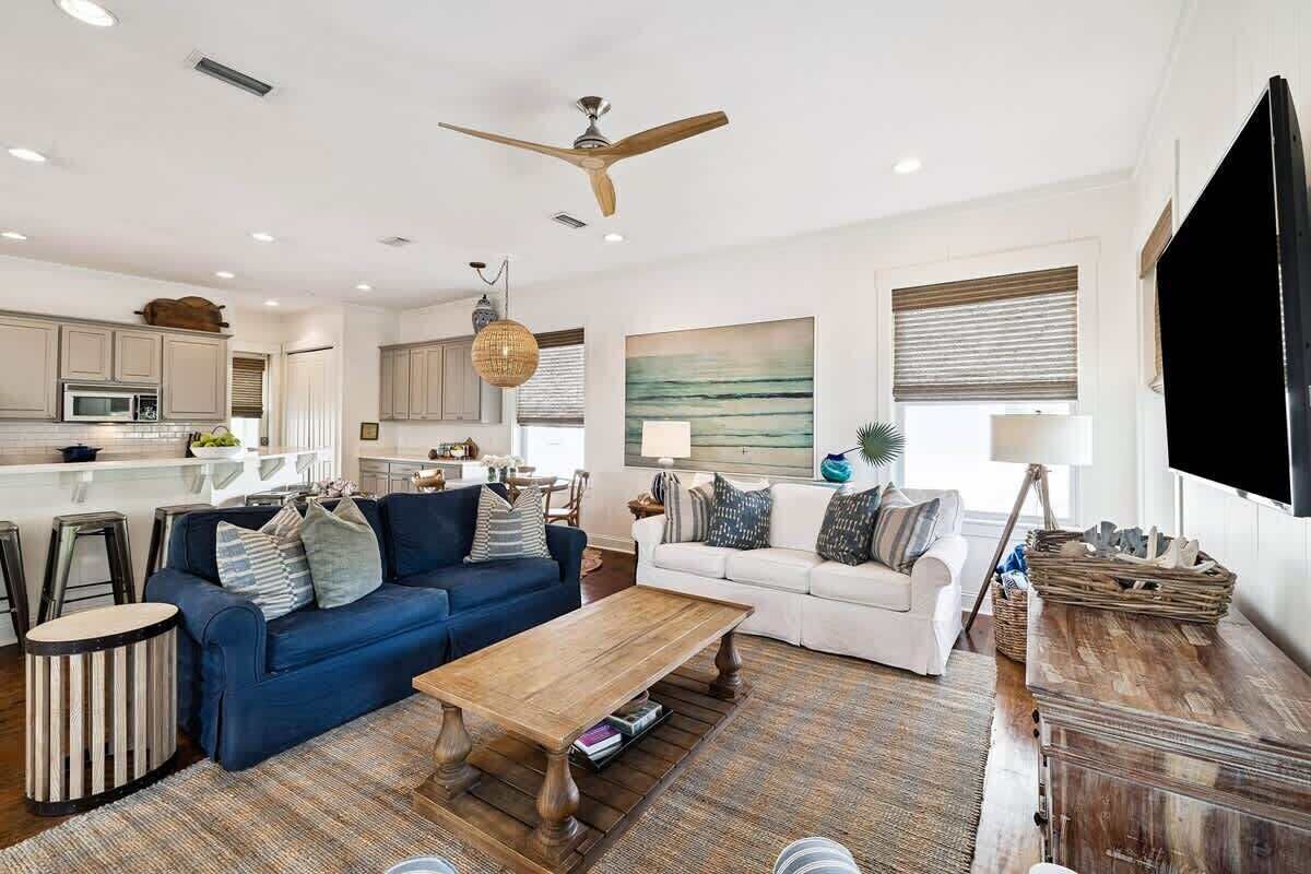 A spacious living area with a sofa, coffee table, and TV.