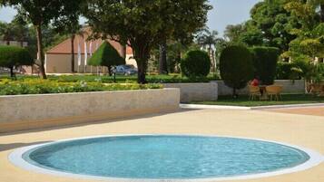 Outdoor pool, pool umbrellas, lifeguards on site