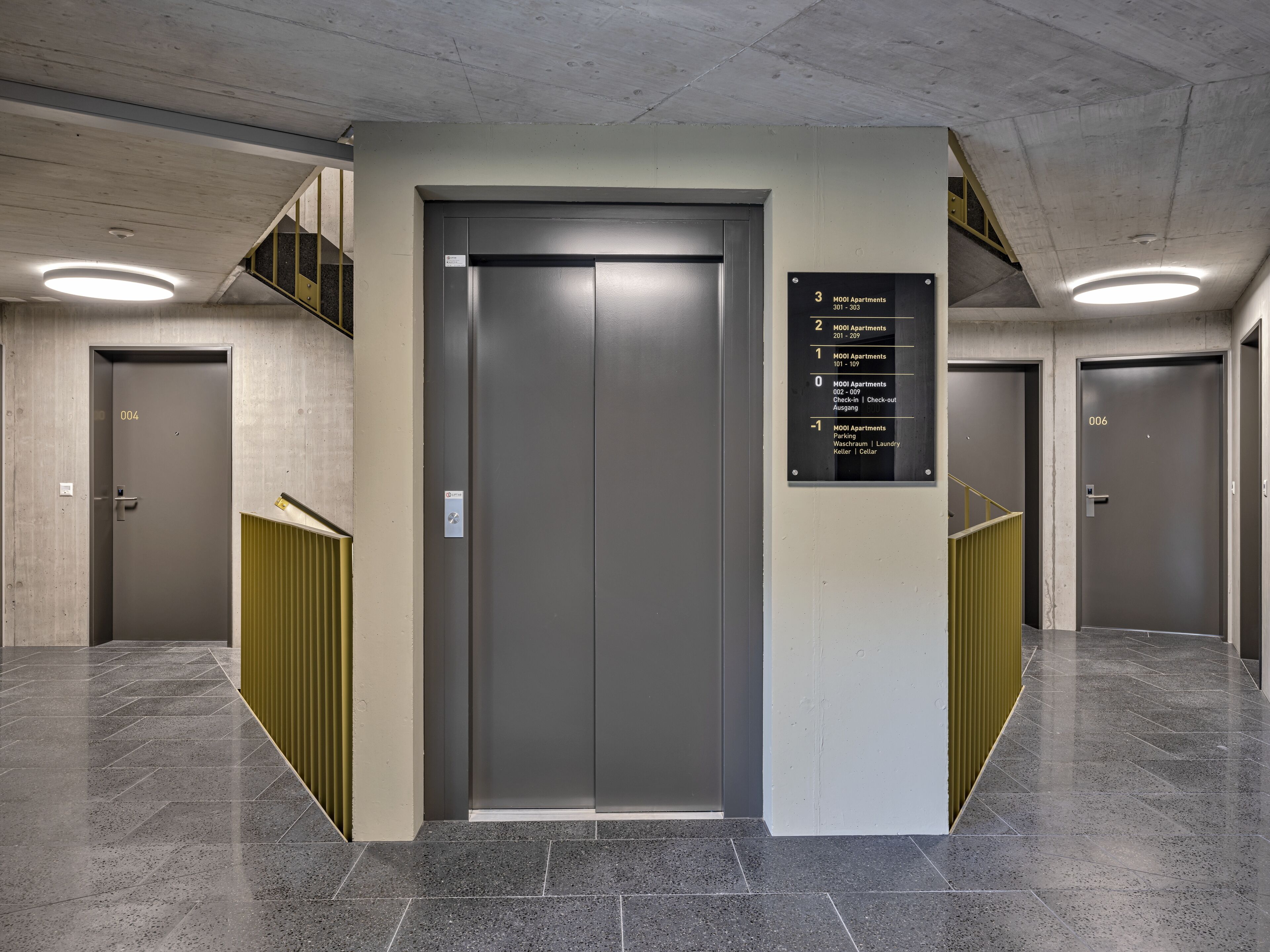 An elevator with a sign listing room numbers and their corresponding floor levels.
