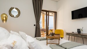 A hotel room with a bed, a desk, a chair, a TV, and a balcony with a view. - Villa Skyfall (Bibinje)