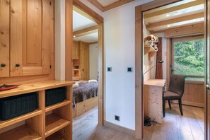 A wooden interior with a bed, a desk, and a chair. - Two bedroom apartment, recently renovated with great style.<br><br>The apartment is distributed as follo (Verbier)