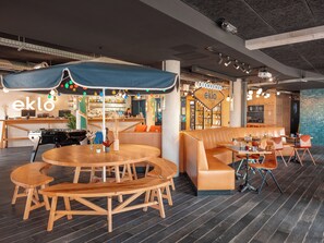 A modern bar area with a bar counter, seating, and a 'Welcome' sign. - Eklo Hotels Paris Roissy CDG Airport  (Roissy-en-France)