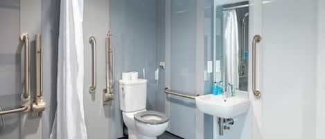 A modern bathroom with a toilet, sink, and shower.